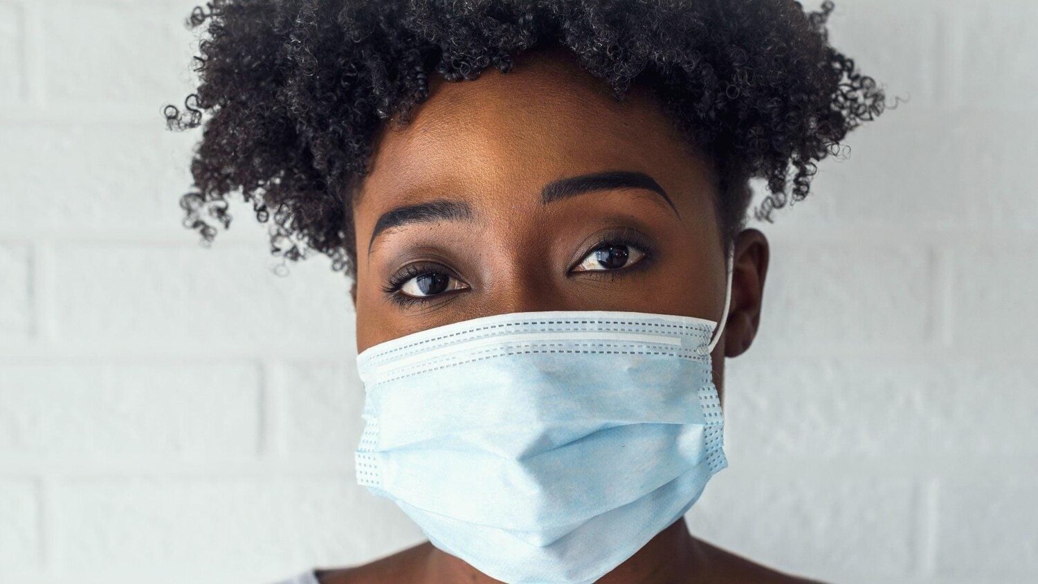 Black woman wearing a medivcal mask